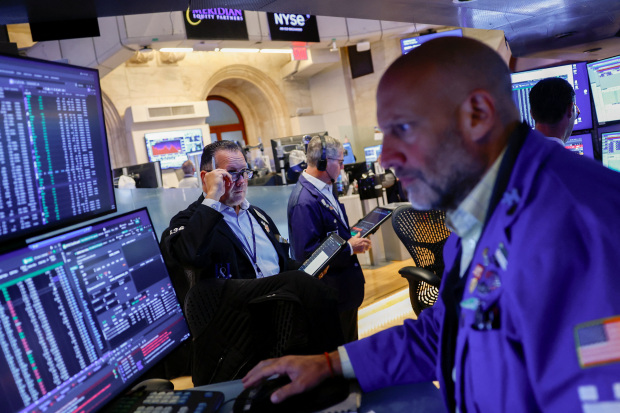 Stocks slide while oil continues to rise